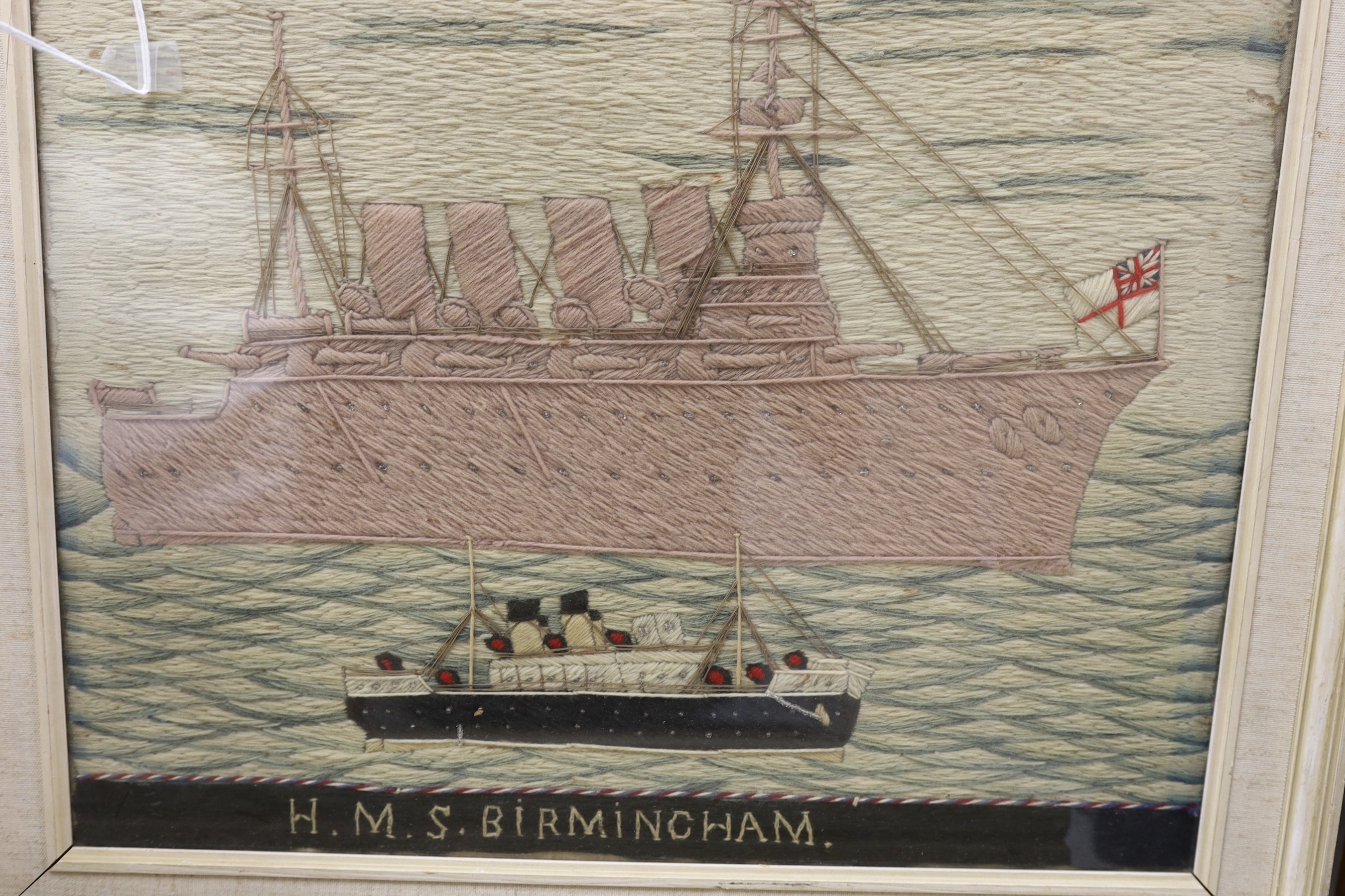 A pair of woolwork ship portraits, HMS Birmingham and Russian Warship Peresviet, a smaller woolwork of a sailing boat and a Berlin woolwork of a biblical scene, HMS Birmingham: 49cms wide x 39cm high